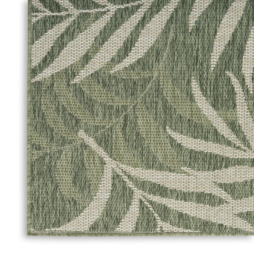 Green and ivory area rug close-up of woven diagonal palm leaf stripes