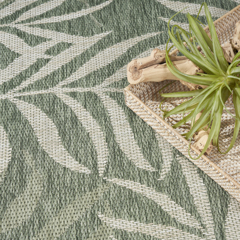 Green and ivory indoor outdoor area rug with textured palm leaf and stripe pattern