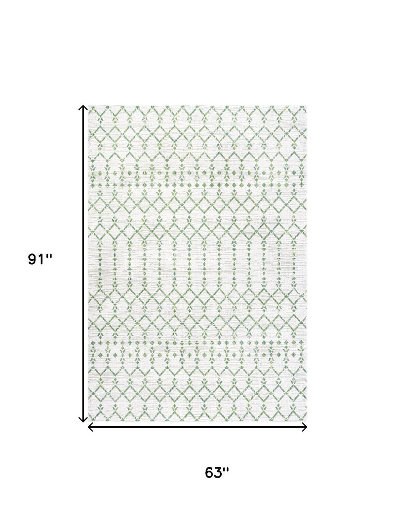 Ivory area rug with green trellis pattern, 63 in x 91 in dimensions