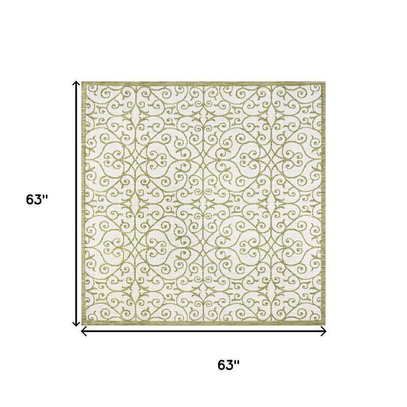 Indoor-outdoor square area rug layout, cream with green scrollwork pattern, 63 in