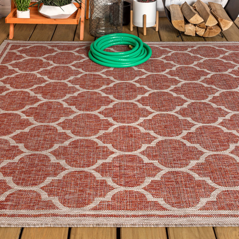 Red and beige geometric area rug with repeating trellis lattice pattern