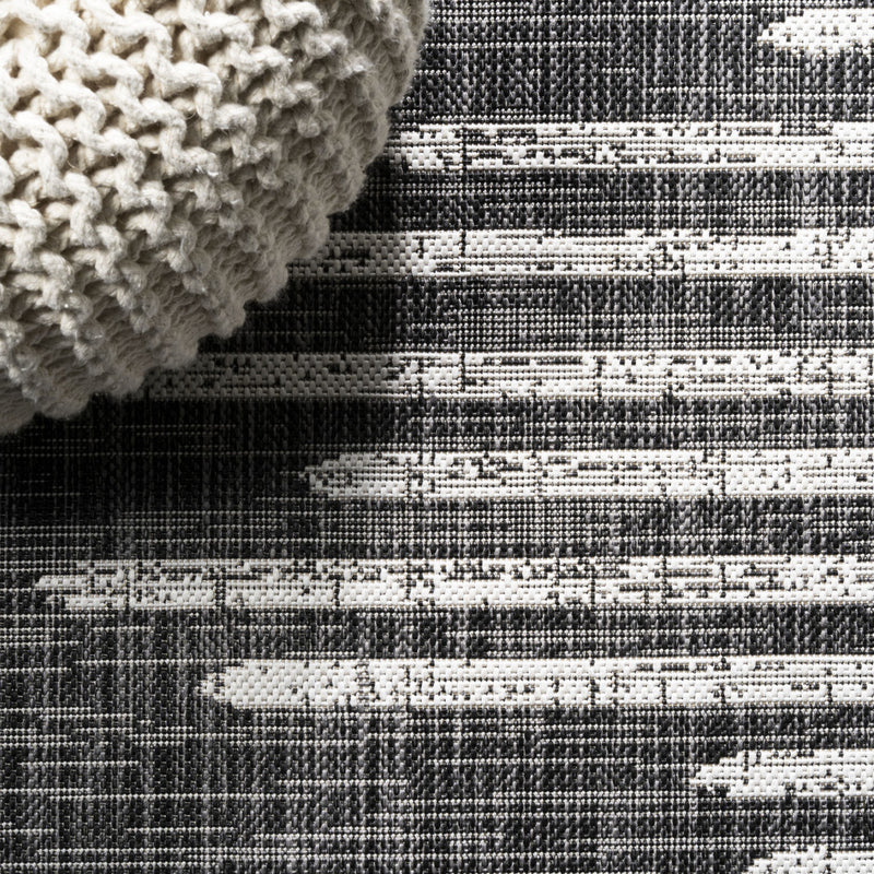 Black-and-ivory striped rug texture with dense looped surface, close-up