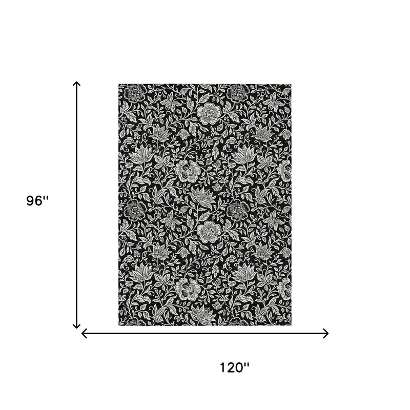 8 x 10 ft black and ivory floral area rug with dense leaf-and-bloom pattern