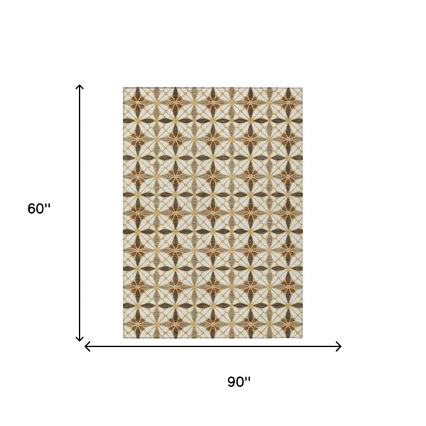 Geometric area rug with cream background and gold, brown, and charcoal starburst pattern