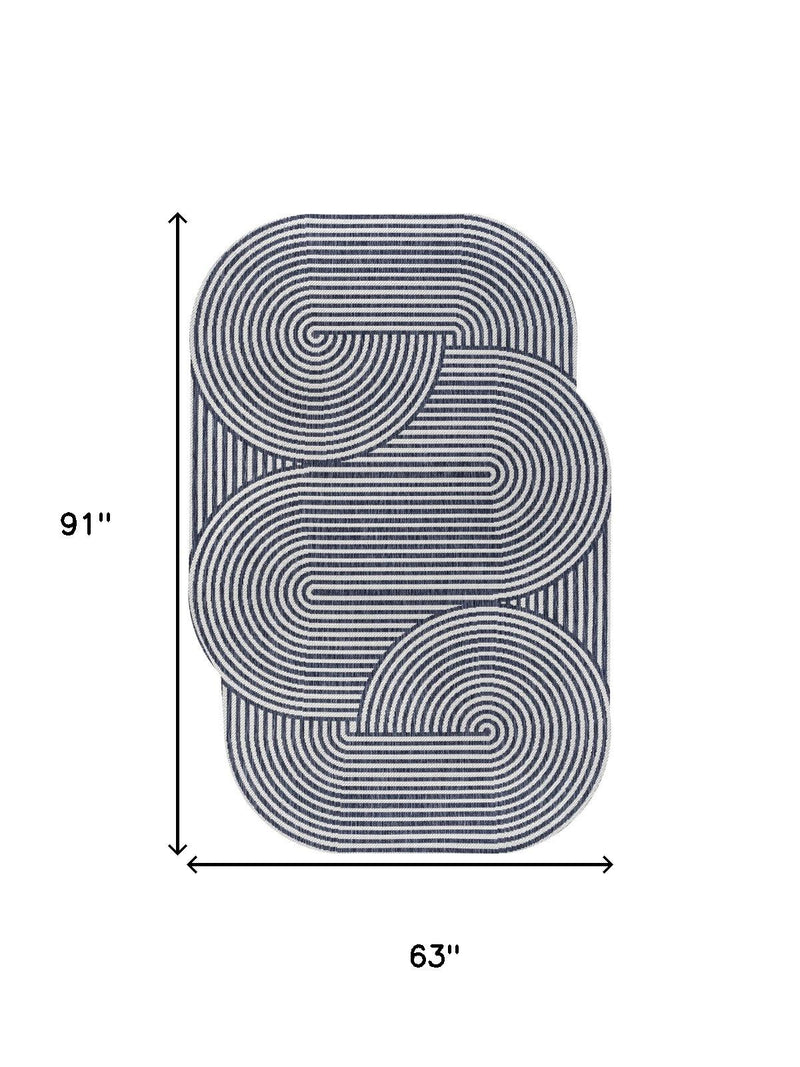 Cream and navy abstract area rug, 63 x 91 in, rounded rectangular design.