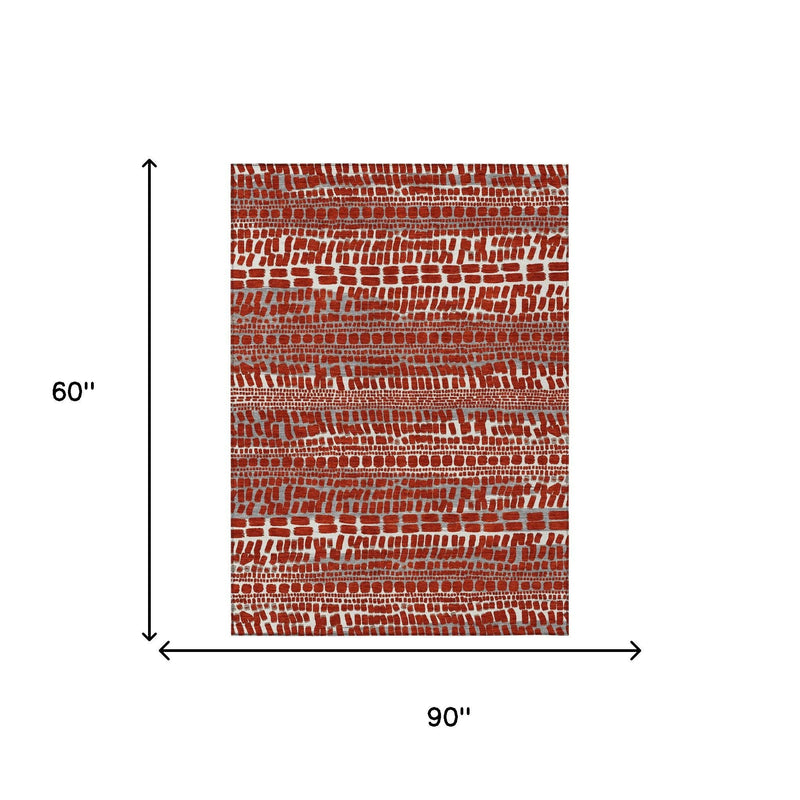 Red abstract area rug, 60 x 90 in, brick-pattern design with gray accents.