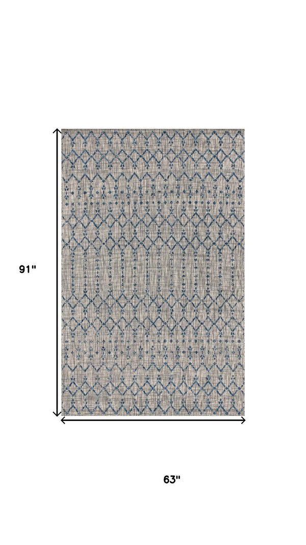 Rectangular light gray rug with navy trellis diamond pattern, 5x8 ft
