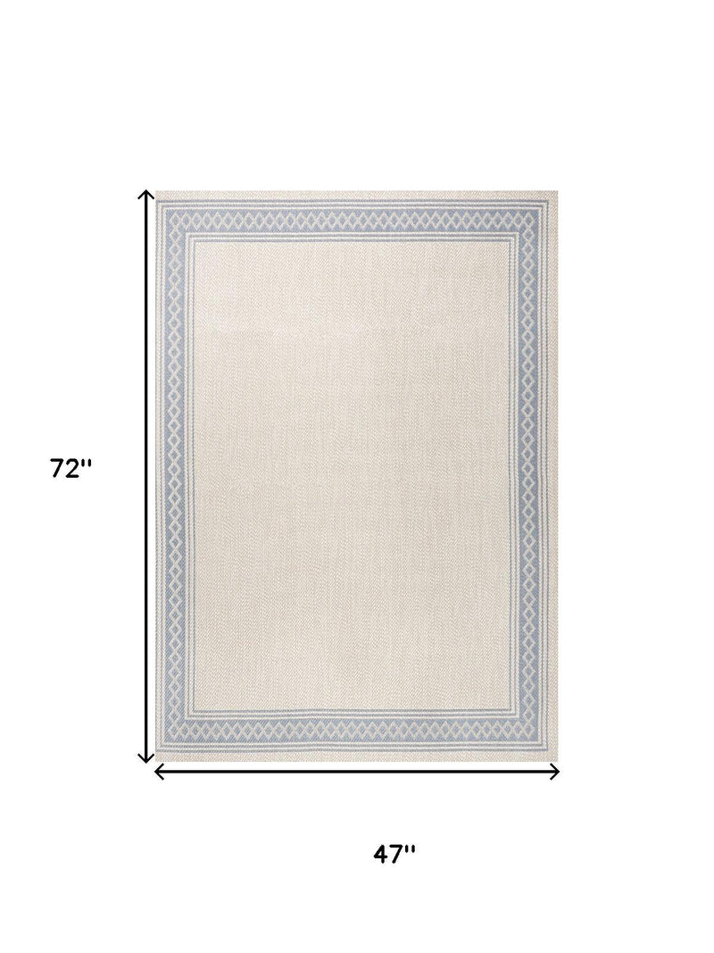 Cream and blue area rug outline, 47 in x 72 in, geometric border