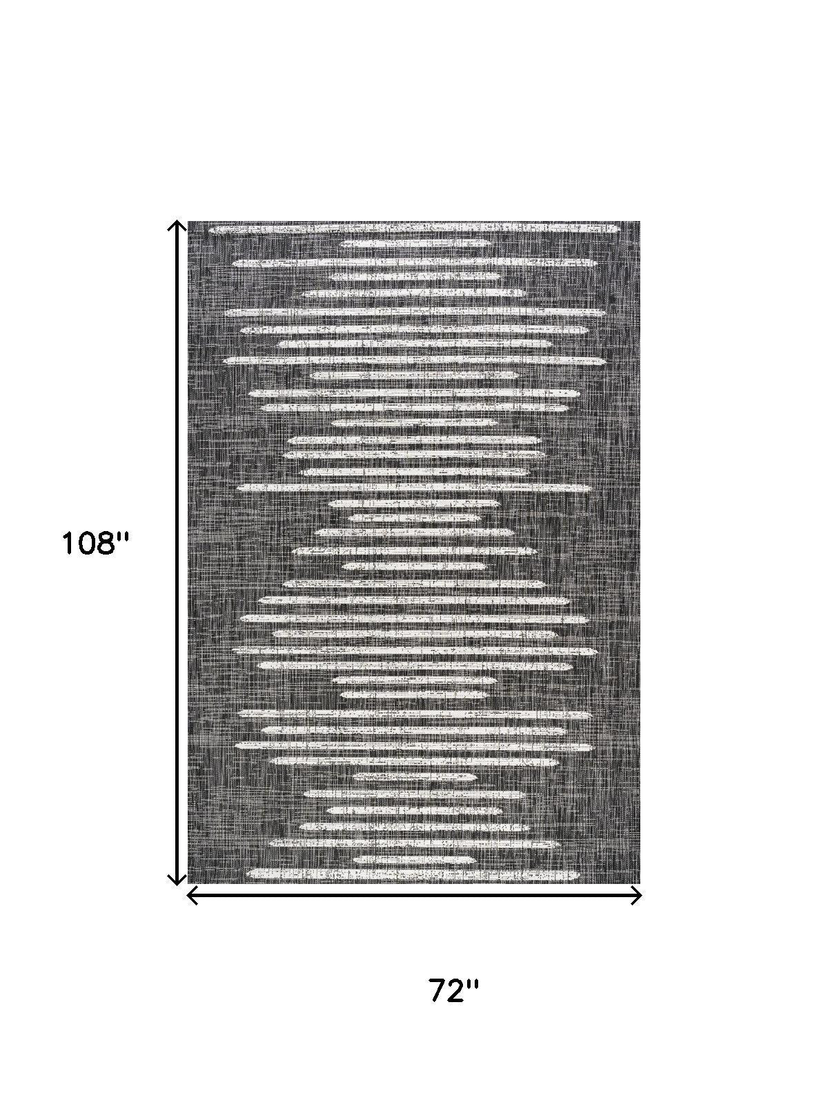 Indoor/outdoor area rug with dark charcoal and ivory striped abstract pattern, full view