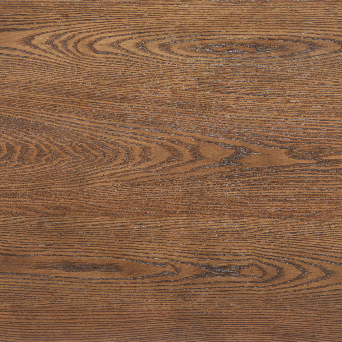 Close-up of brown wood grain on the coffee table surface with visible swirling texture.