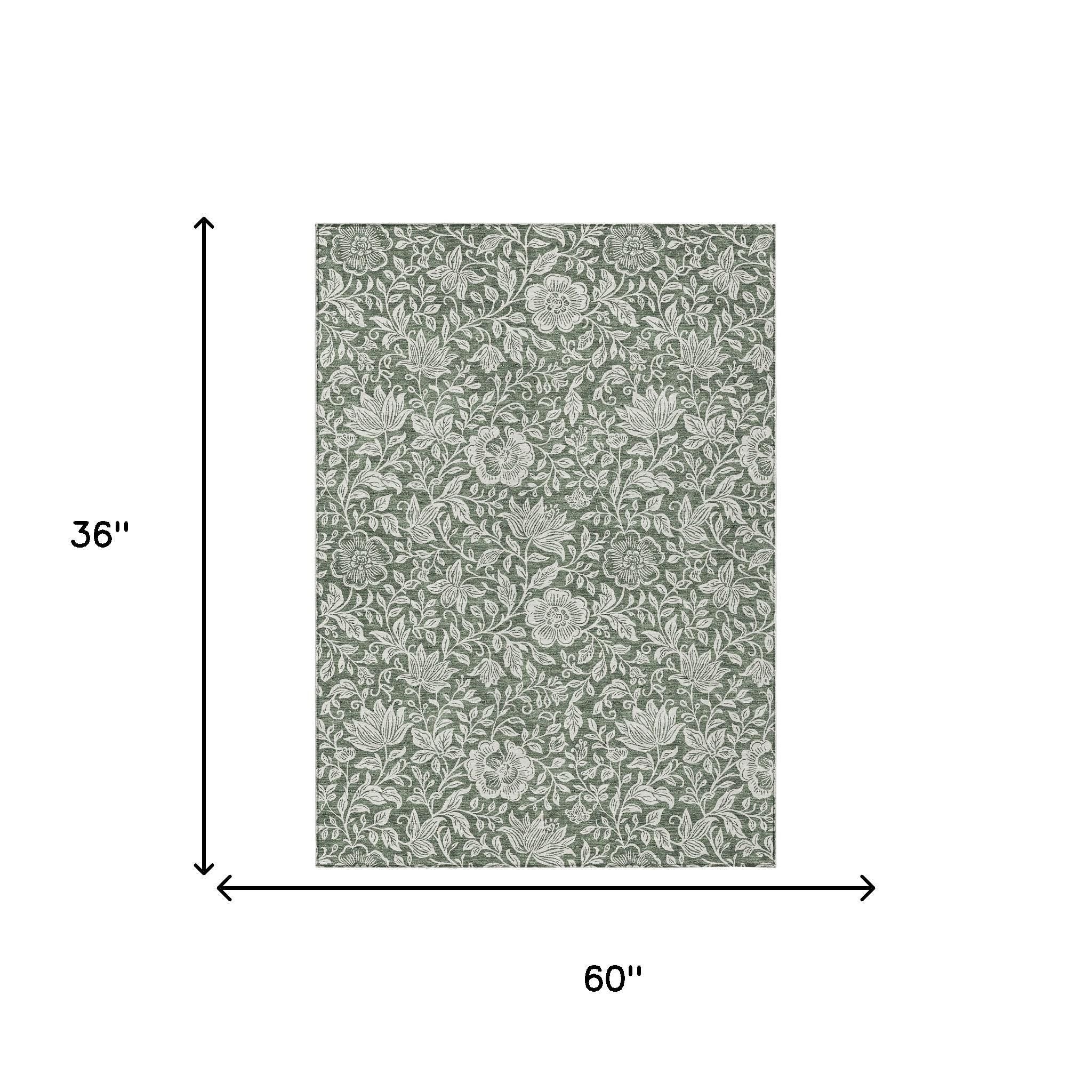 Green rug with ivory floral pattern, size 60 in x 36 in.