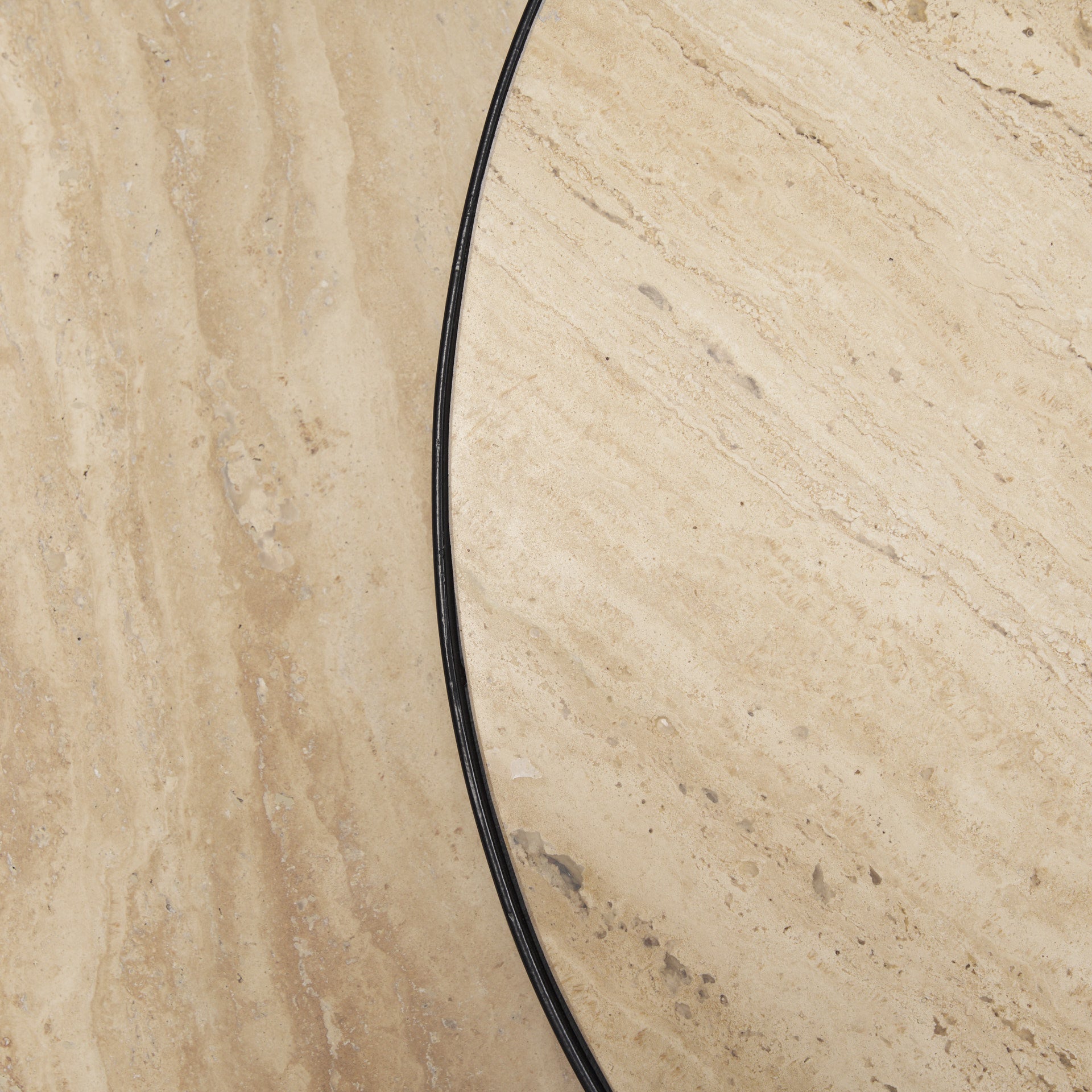 Close-up of beige stone-look tabletop surface with black outer rim