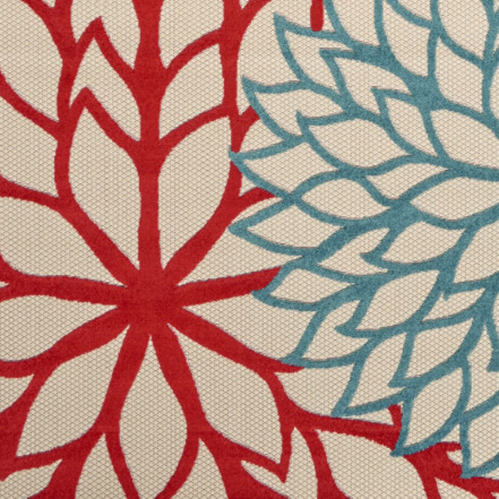 Ivory area rug close-up: red flower with teal-blue leaf pattern