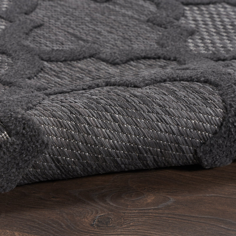 Close-up of charcoal trellis runner rug texture with short, dense fibers