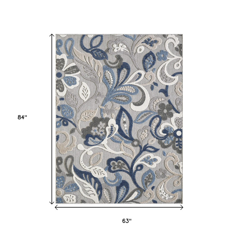 Indoor/outdoor area rug, rectangular gray base with blue and white floral pattern, top view
