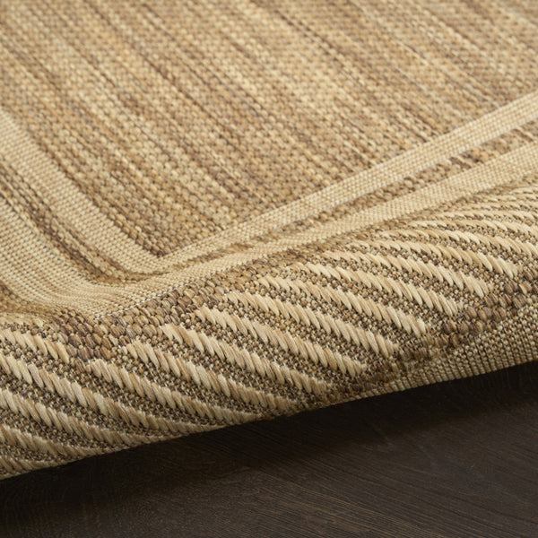 Natural woven indoor/outdoor area rug with geometric border pattern