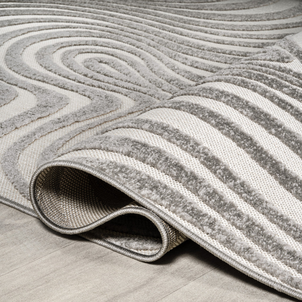 Gray and ivory indoor outdoor rug with bound edge and low textured pile