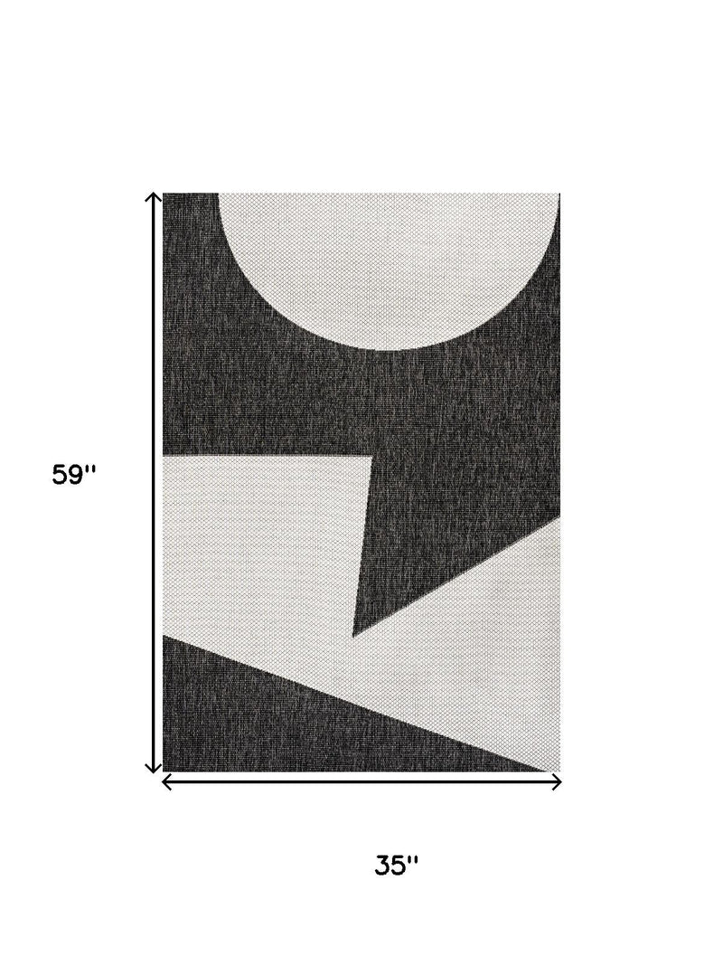 Geometric area rug, 3 ft x 5 ft, black with cream shapes