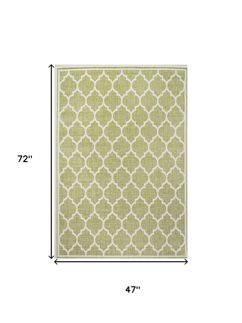 Green and cream geometric area rug with size dimensions 72 in by 47 in