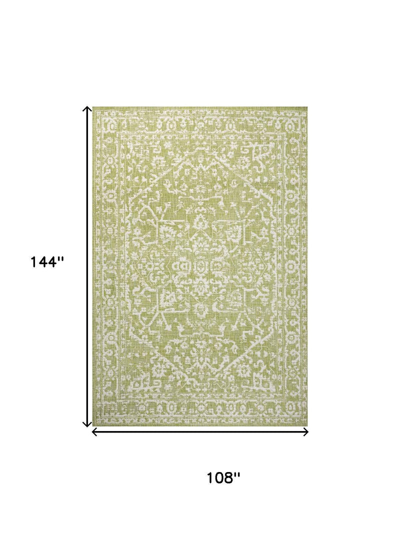 Green and cream medallion area rug with size diagram on white background