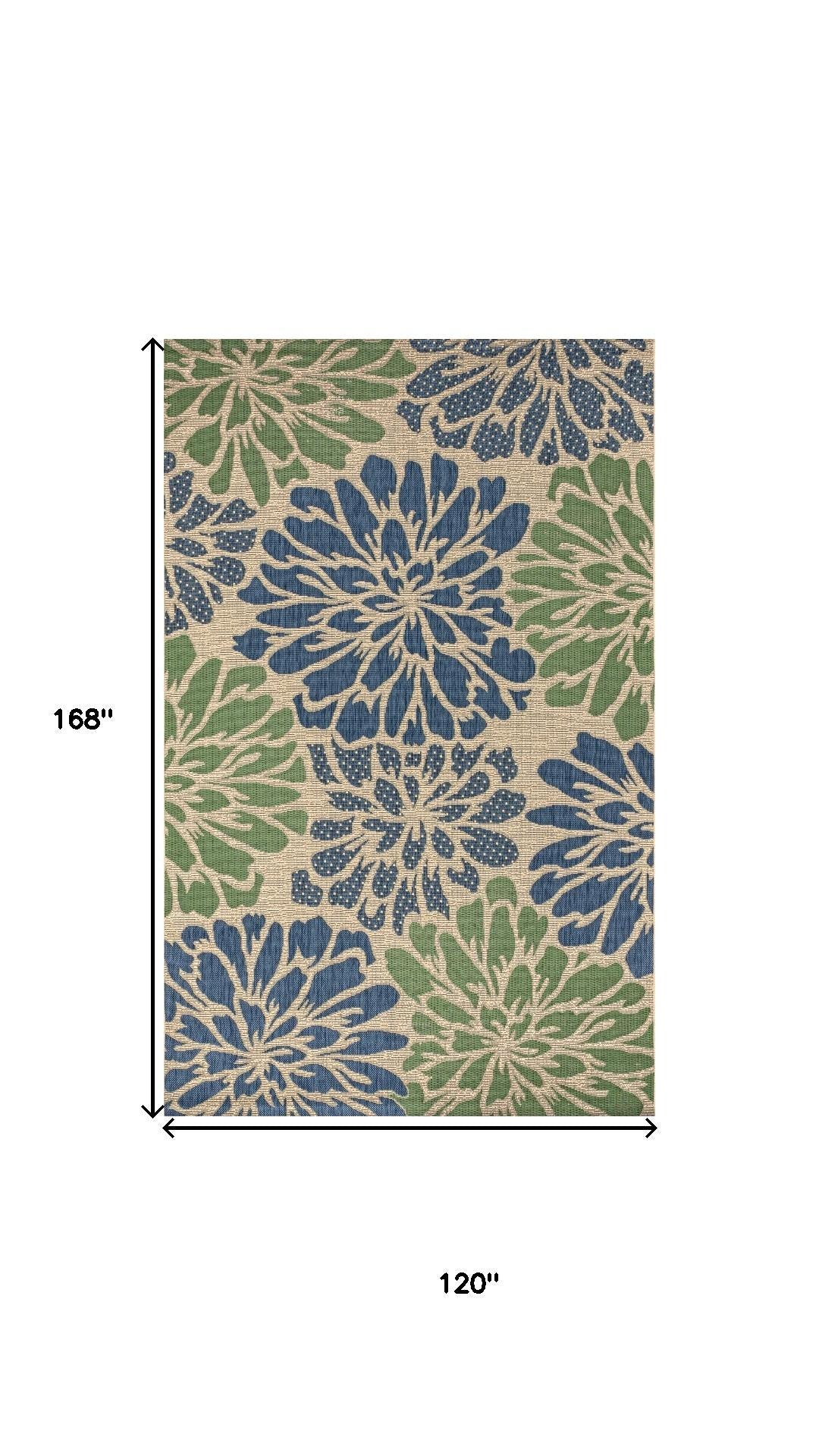 Indoor/outdoor area rug with navy and green floral medallions and thin border