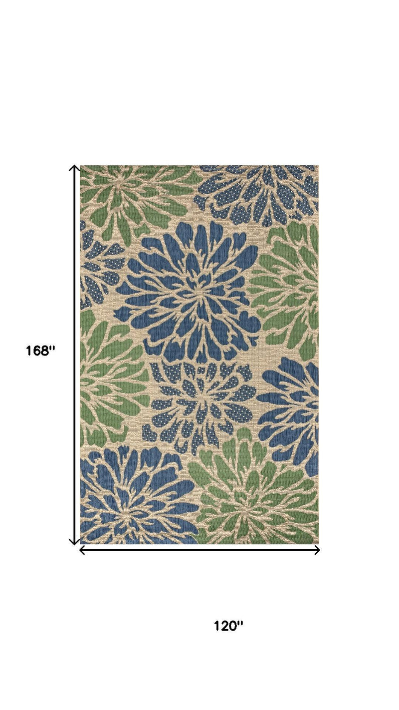 Indoor/outdoor area rug with navy and green floral medallions and thin border