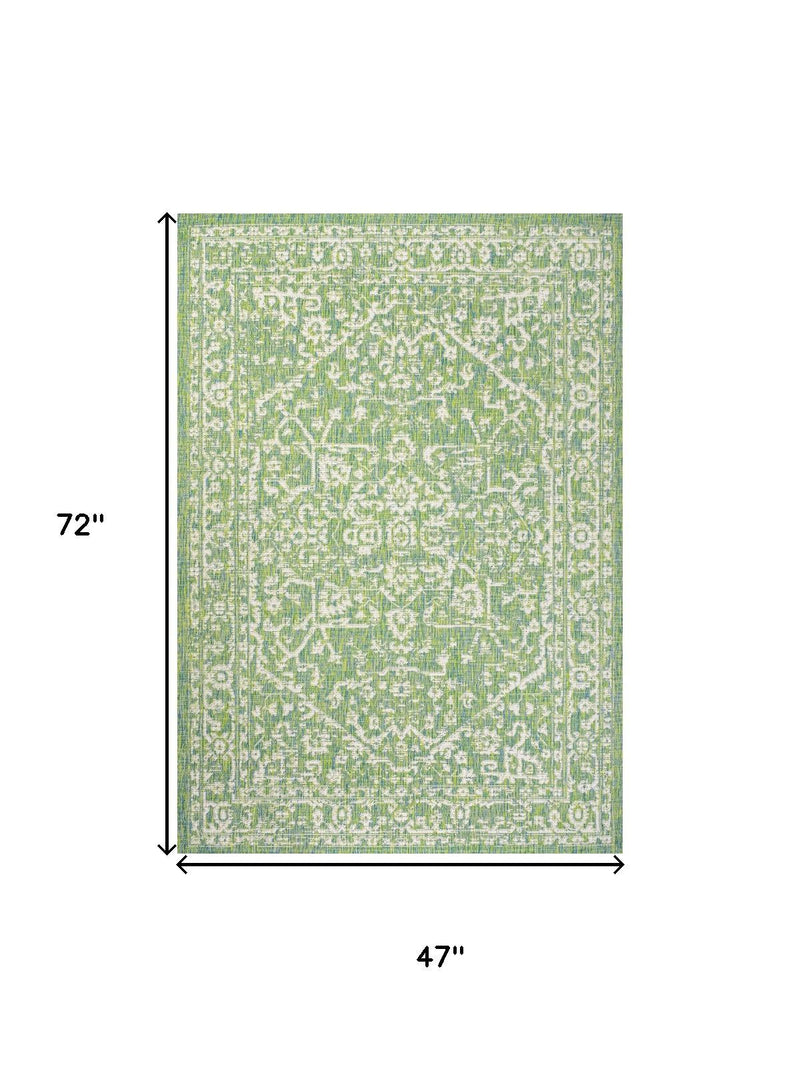 Cream and green medallion area rug, 4 ft x 6 ft (47 in x 72 in).