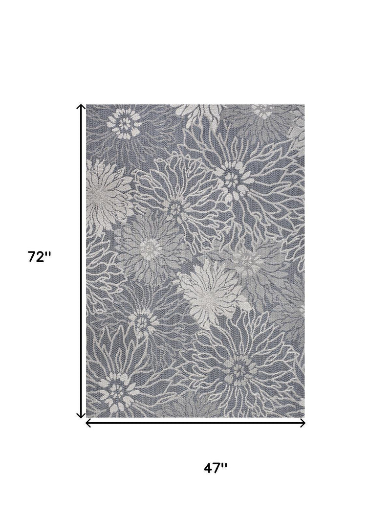 Indoor outdoor area rug with gray and navy floral pattern, 72 in x 47 in