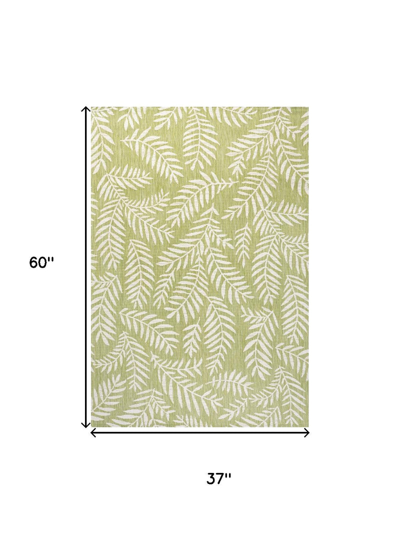 Green and cream indoor/outdoor rug, 37 by 60 inches, fern leaf pattern