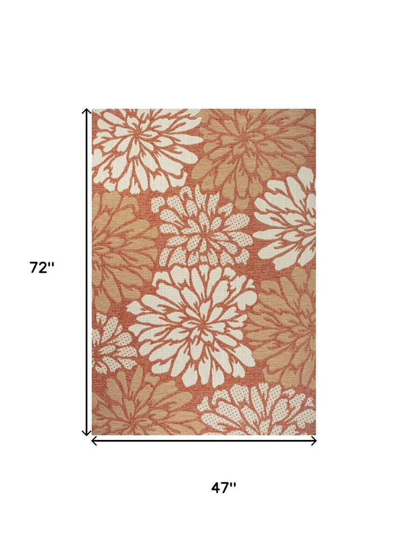 Orange and cream floral area rug, 4 ft by 6 ft, daisy-style flower pattern