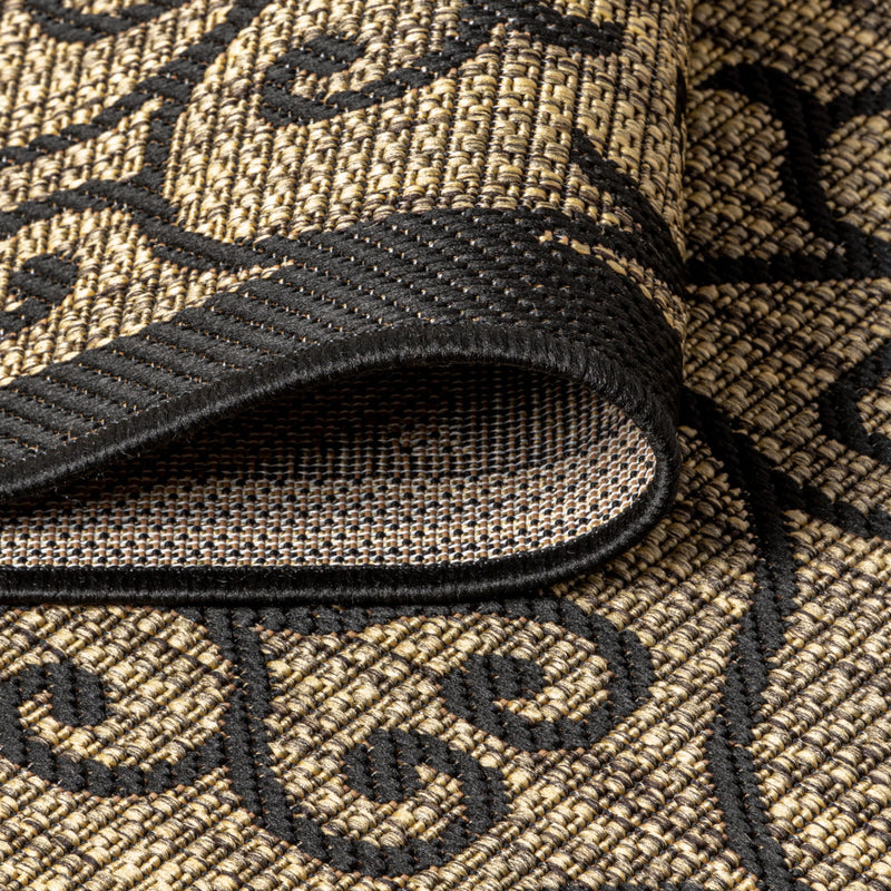 Woven black and khaki area rug texture with curled swirl pattern