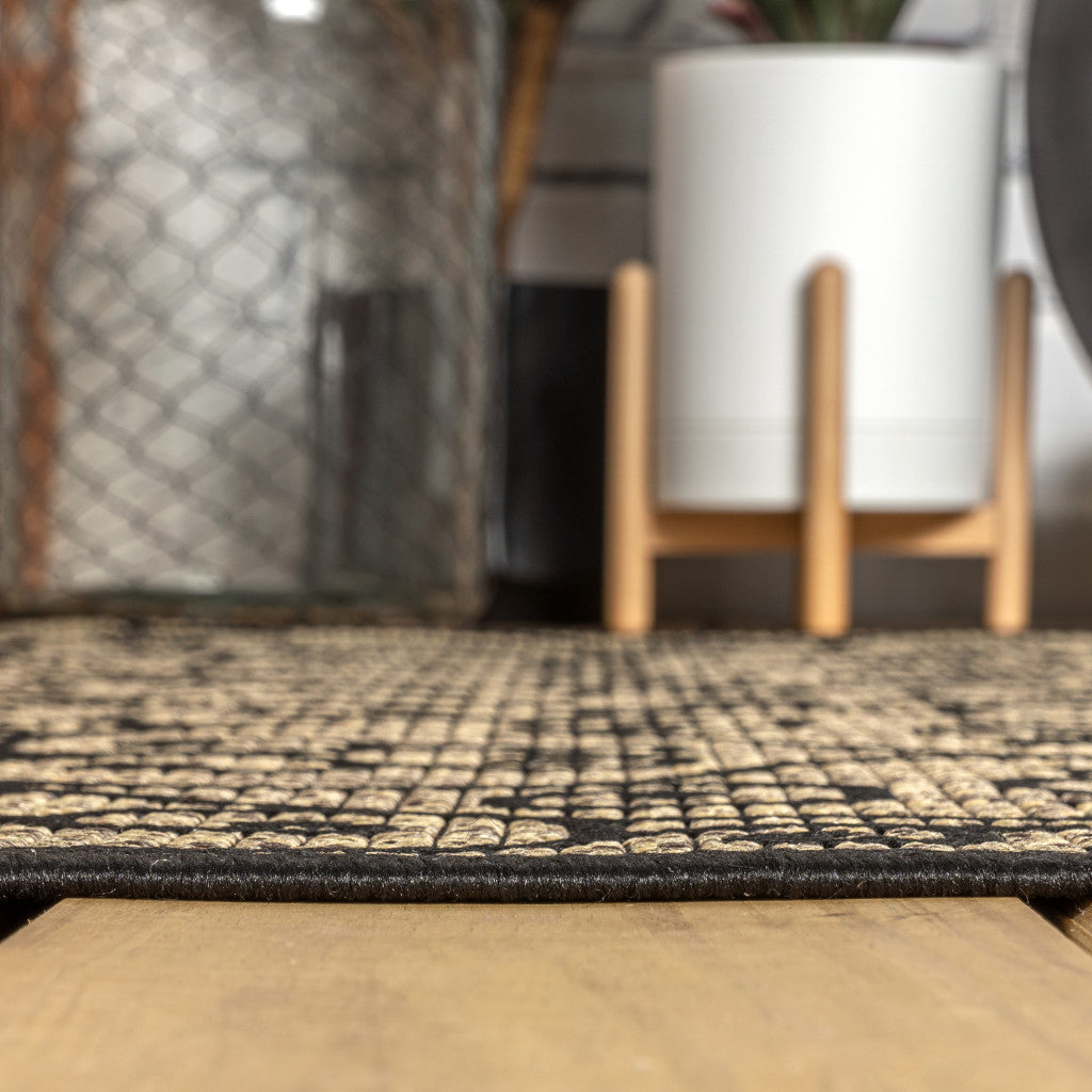 Round black-and-khaki geometric area rug with interlocking lattice pattern