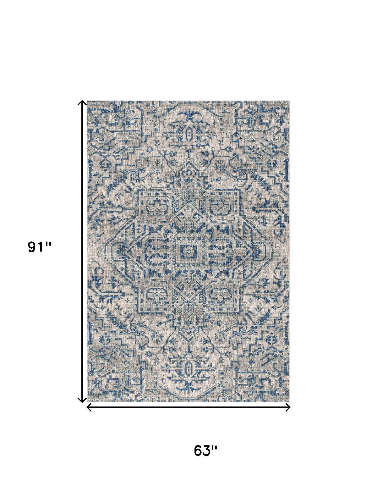 Indoor outdoor rug with blue-gray medallion pattern, 63 x 91 in