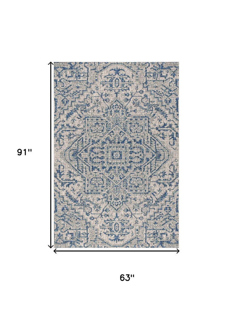 Indoor outdoor rug with blue-gray medallion pattern, 63 x 91 in