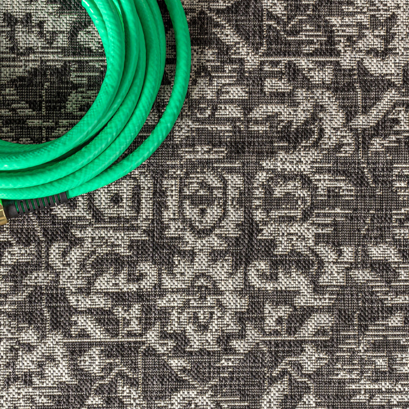 Close-up of black and gray medallion rug texture and motif pattern