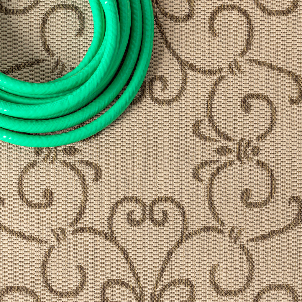 Close-up of beige rug fabric with brown scroll medallion and woven texture