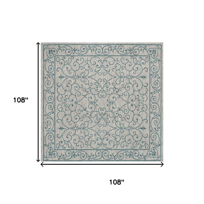 Square area rug diagram style showing light gray with teal decorative border pattern.