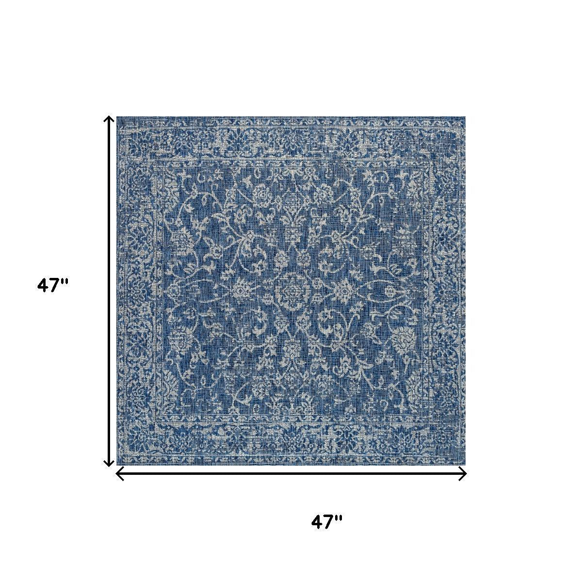 Navy and gray square indoor/outdoor area rug with ornate medallion pattern and border