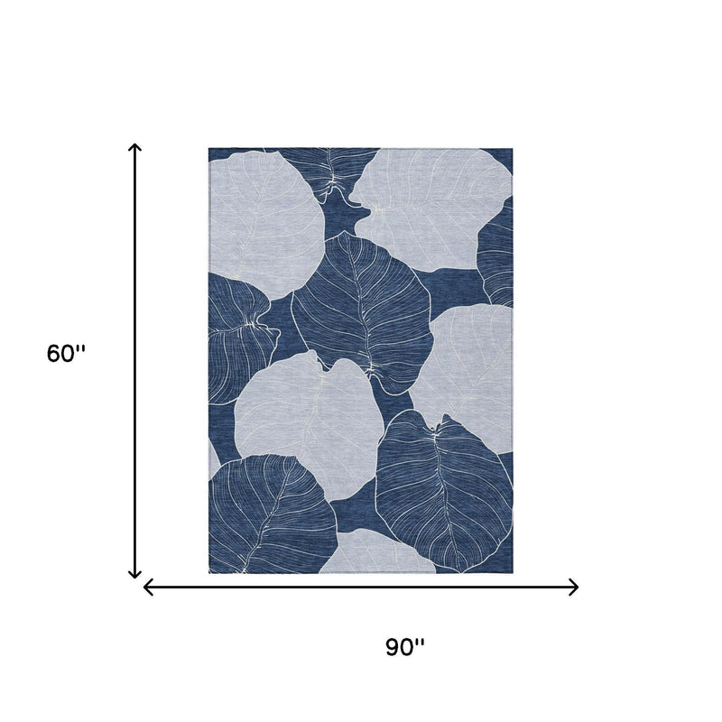Rectangular area rug with navy and ivory leaf pattern; 90" x 60" size shown.