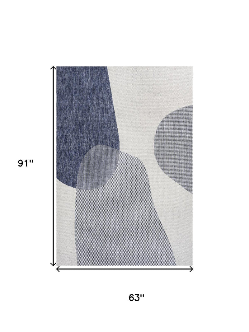 Cream and navy geometric area rug panel with abstract ovals, vertical view