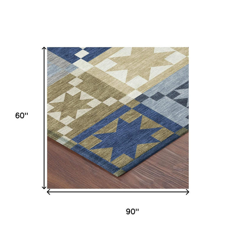 90 in x 60 in patchwork area rug in blue, tan, and cream with star motifs