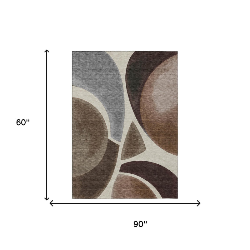 Abstract area rug, 5 x 8 ft, with gray, brown, and beige curved swirls and cream lines