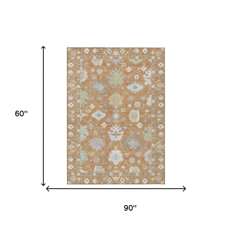 Indoor/outdoor area rug, copper and gold with light blue medallion border; 5' x 8'