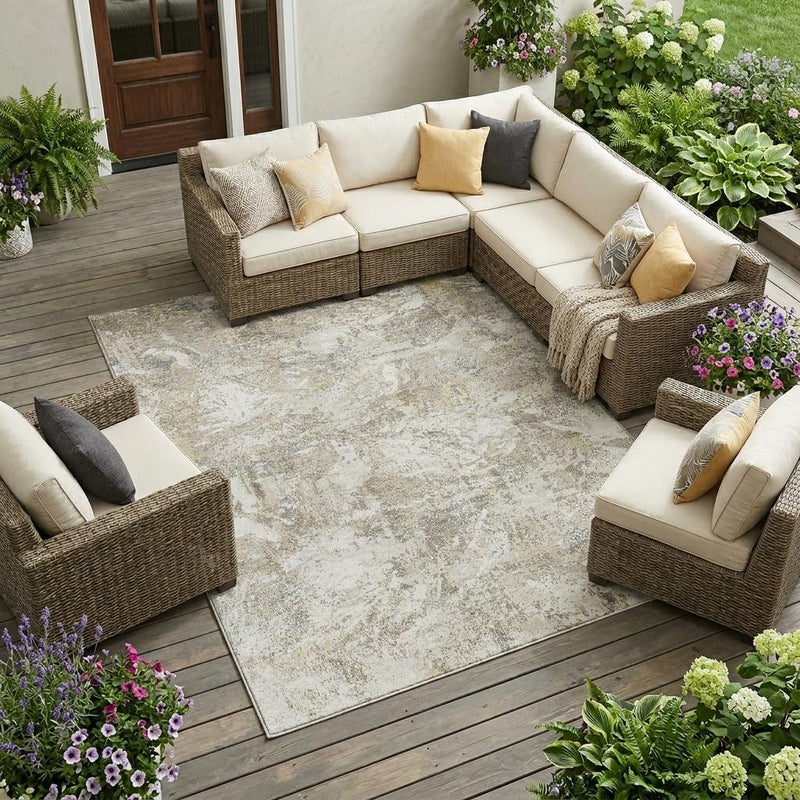 Ivory and silver abstract area rug with distressed texture under outdoor seating