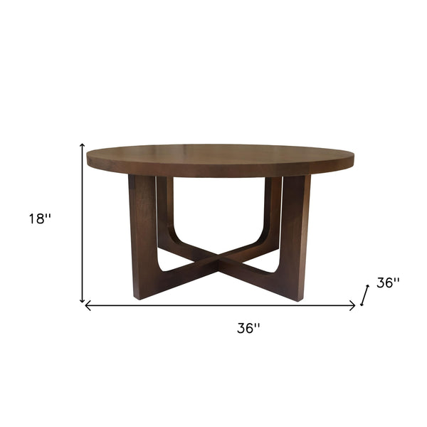 Brown solid wood round coffee table with X-style cross legs and flat round top