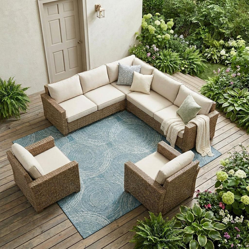 Teal blue geometric outdoor area rug with ivory circular medallions on deck flooring