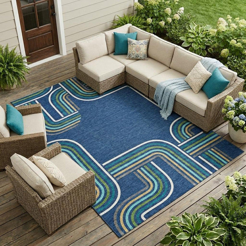 Geometric area rug with navy blue base and aqua stripe lines laid out for outdoor seating