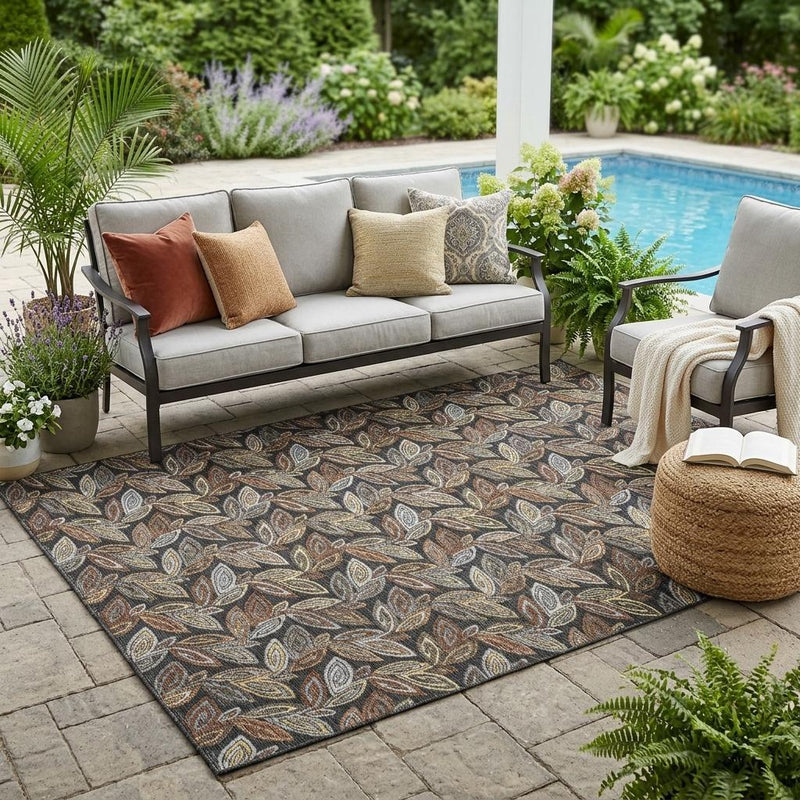 Botanical leaf pattern area rug in dark charcoal with gray and orange undertones