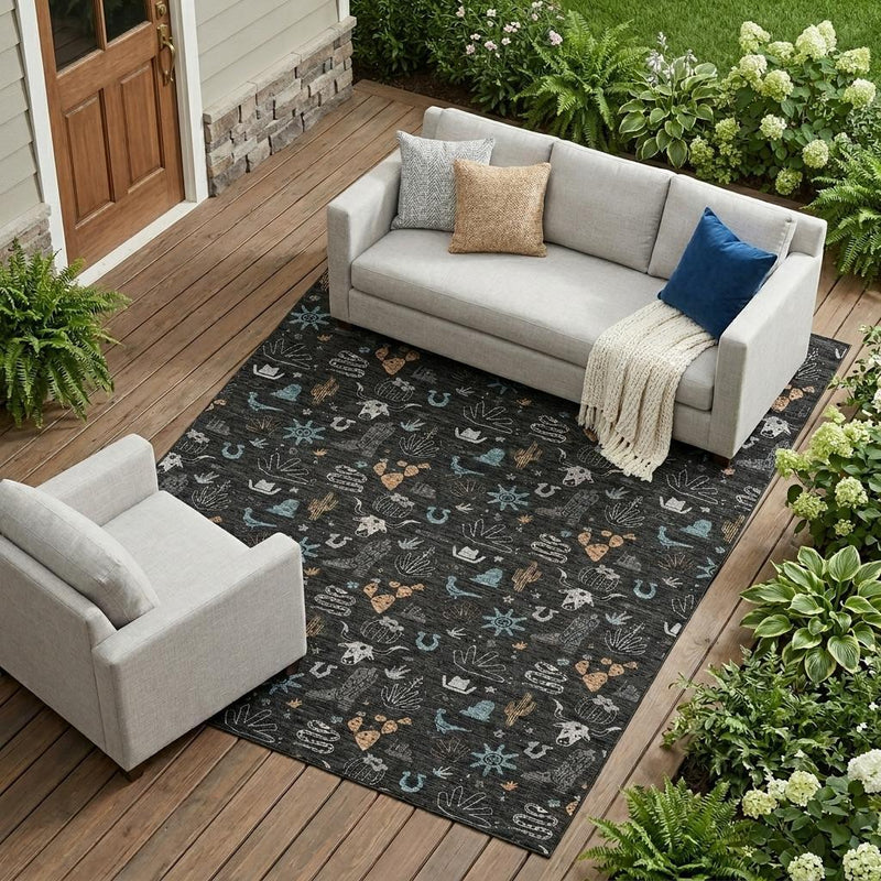 Black cactus area rug on an outdoor wooden patio with teal and tan pattern