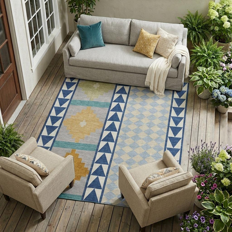 Indoor/outdoor area rug with blue, teal, and tan southwestern geometric design